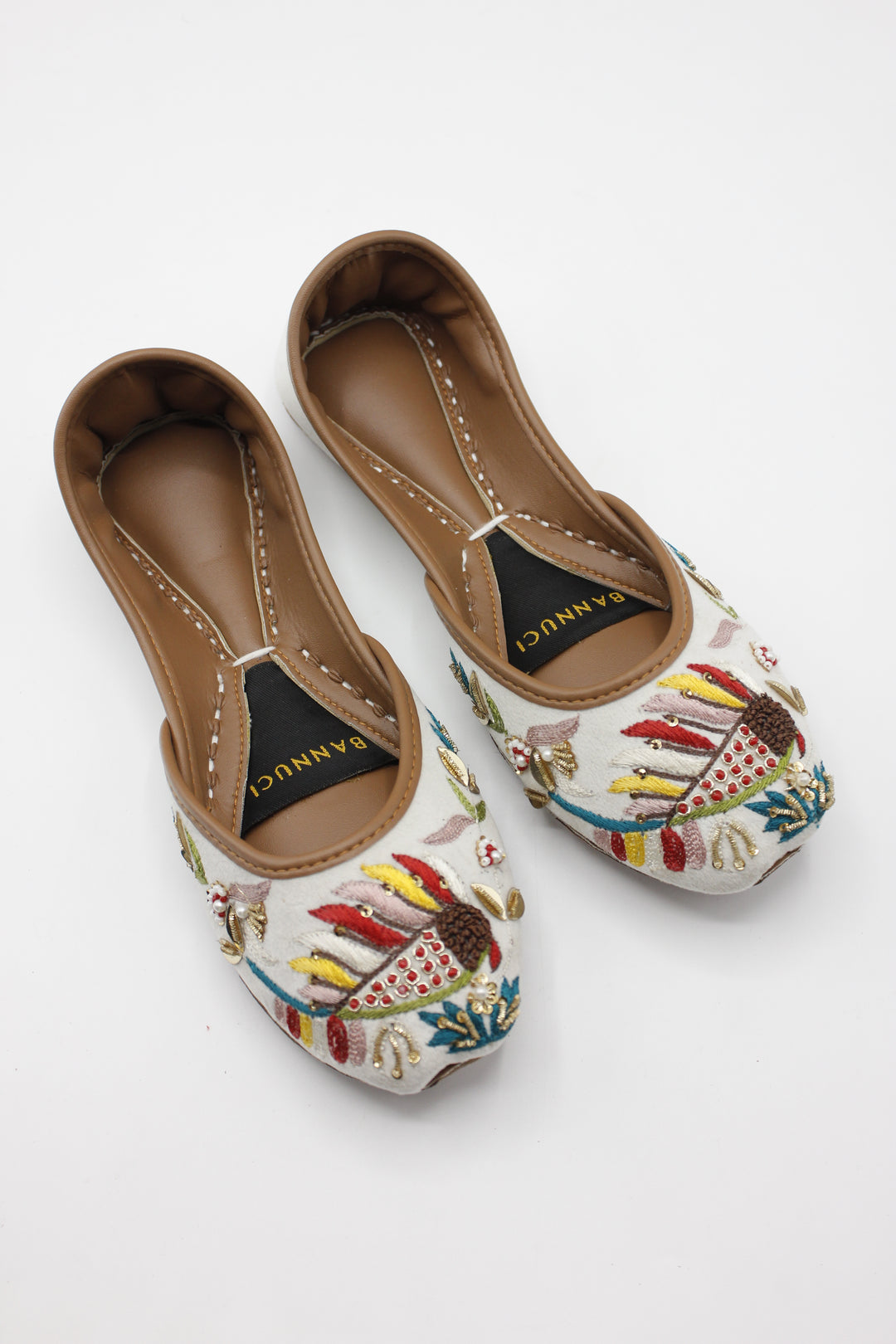 How Custom Khussa Shoes Add a Personal Touch to Your Outfit 7 https://bannuci.com/cdn/shop/files/PremiumQualityWhiteMultiColorEmbroideredKhussas_1.jpg?v=1721385035&width=1080